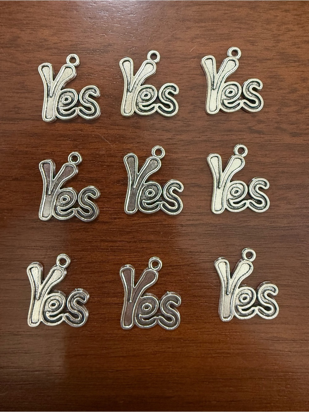 Silver Tone “Yes” Charms - 9 Total
